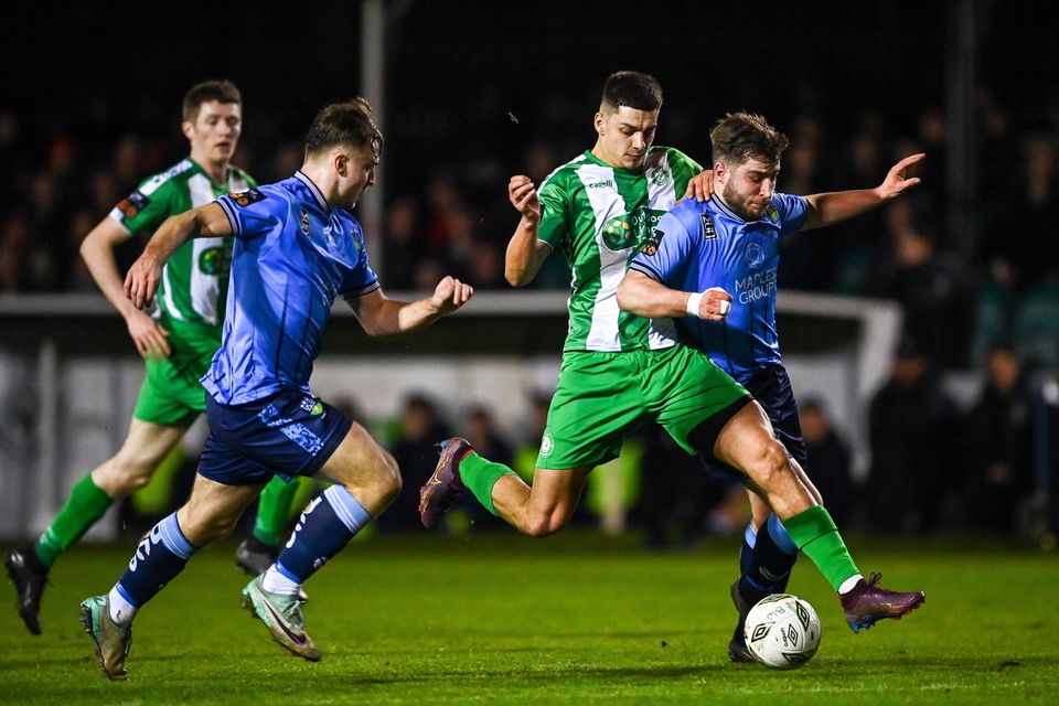 Cristian Magerusan of Bray Wanderers is tackled by Alex Dunne of UCD at the Carlisle Grounds. 