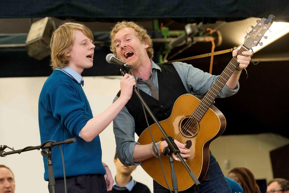 13/09/2013. Pictured is Oscar winner and renowned musician Glen Hansard performing The Frames 'Fake' with student Balaji Block ,15, and the St Tiernan's Community School rock band to celebrate the school's first Green Flag from An Taisce. Photo: El Keegan