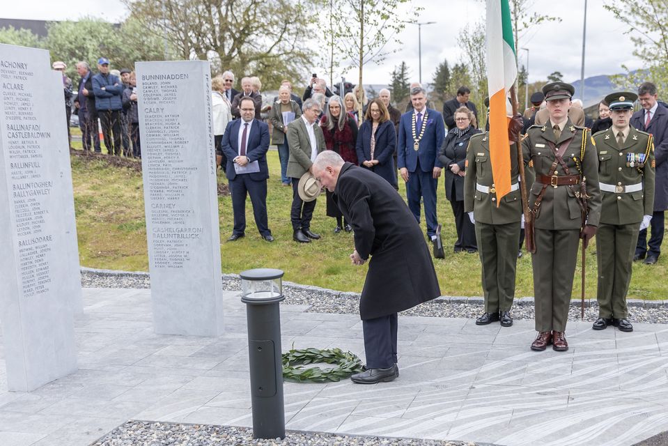 Tommie Gorman lays a wreath at the memorial garden.