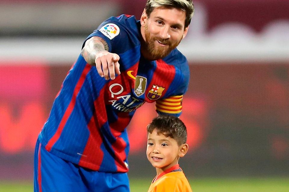 Barcelona’s Lionel Messi meeting Murtaza Ahmadi in Doha on Tuesday. Photo: Karim Jaafar/AFP/Getty Images