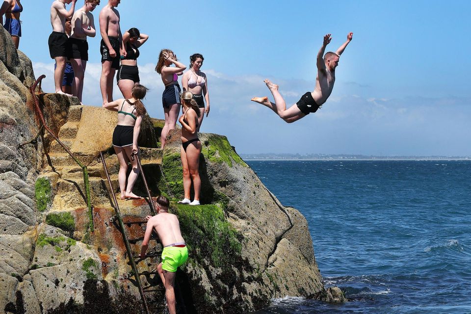 Taking the plunge at the Forty Foot in Sandycove during the sunny weather. Photo: Steve Humphreys