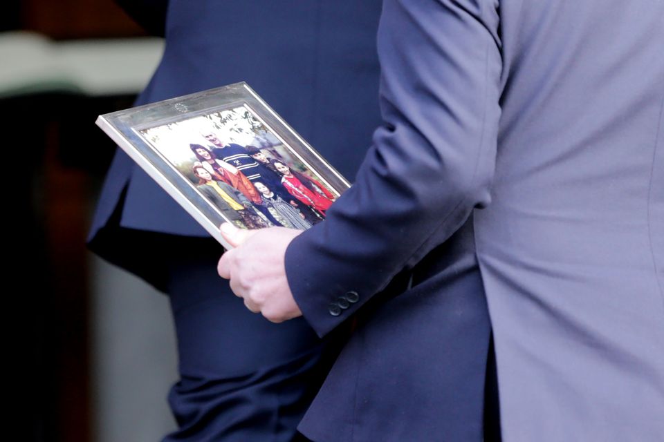 A Bruton family picture is brought to the church. Photo: Gerry Mooney