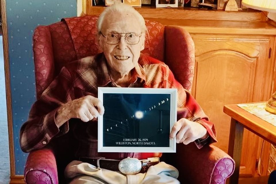 LaVerne Biser, at his home in Fort Worth, Texas, with a photo he took of his favourite solar eclipse in 1979. Photo: Cheryl Torres