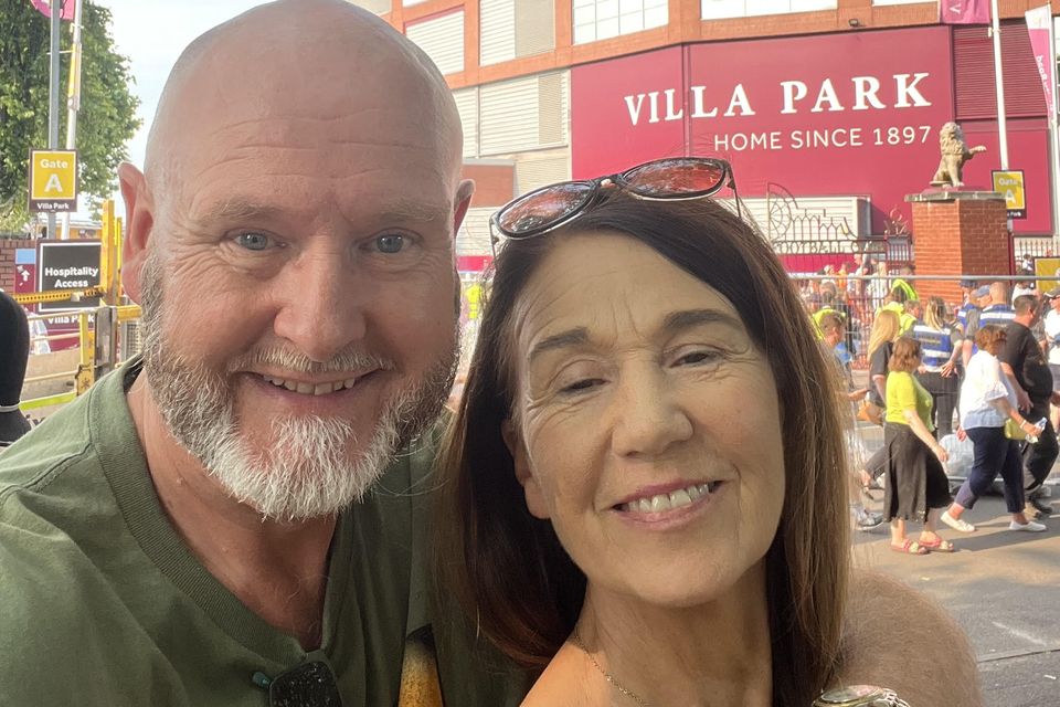 Ralph Riegel outside Villa Park, Birmingham, with his wife Mary, who he met at Slane Castle during a Bruce Springsteen concert 39 years ago