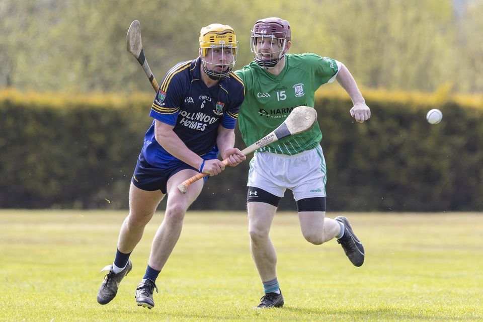 Rory Martin of Western Gaels clears the ball from Des Byrne of Arklow Rocks.