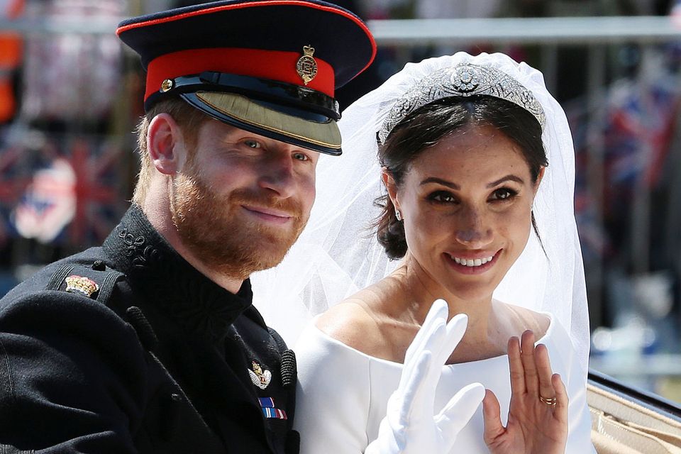 Britain's Prince Harry, Duke of Sussex and his wife Meghan, Duchess of Sussex wave from the Ascot Landau Carriage during their carriage procession on the Long Walk as they head back towards Windsor Castle in Windsor, on May 19, 2018 after their wedding ceremony. (Photo by Aaron Chown / POOL / AFP)