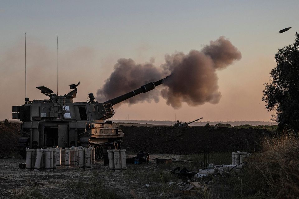 An Israeli artillery unit fires toward targets in Gaza Strip, at the Israeli Gaza border. Photo: AP Photo/Tsafrir Abayov