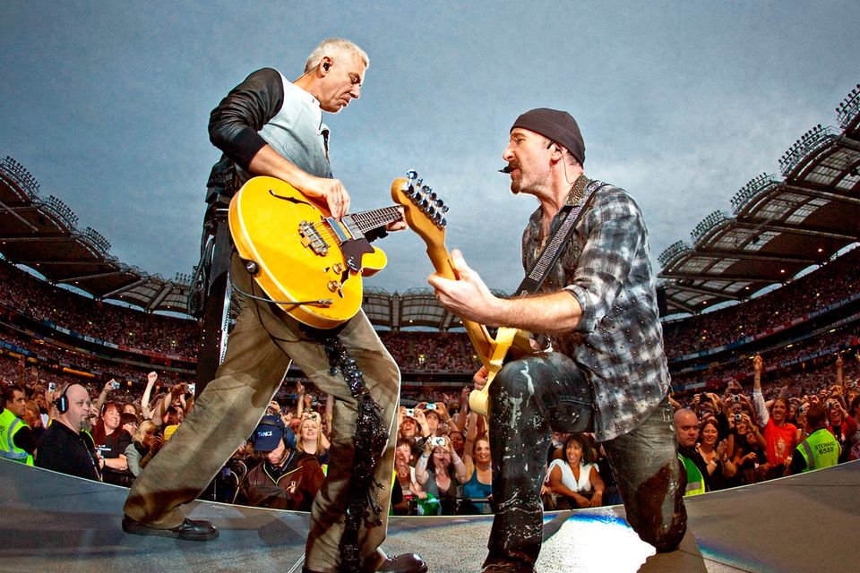 Adam Clayton and The Edge perform during U2's 360 Degrees World Tour at Croke Park on July 25, 2009. Photo by Neil Lupin/Redferns)