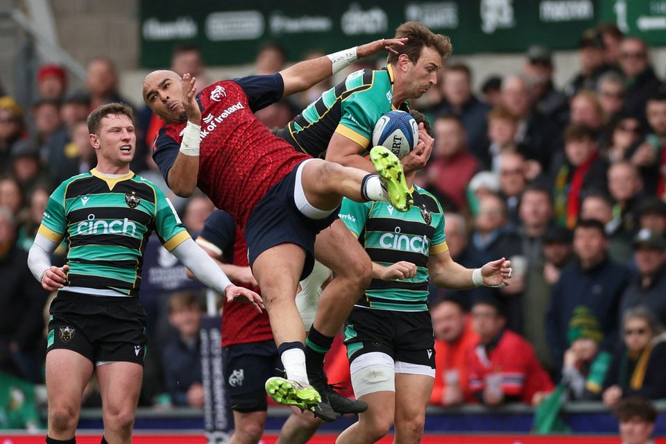 Munster's Simon Zebo in action with Northampton Saints' James Ramm in the European Champions Cup clash at Franklin's Gardens, Northampton