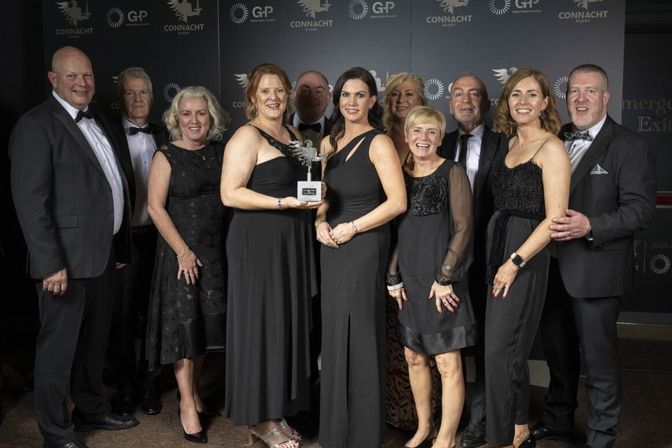 Sligo RFC President Jean McConnell and members of Sligo RFC celebrate the club's award.