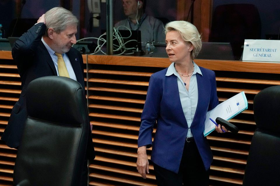 European Commission President Ursula von der Leyen, right, speaks with European Commissioner for Budget and Administration Johannes Hahn 