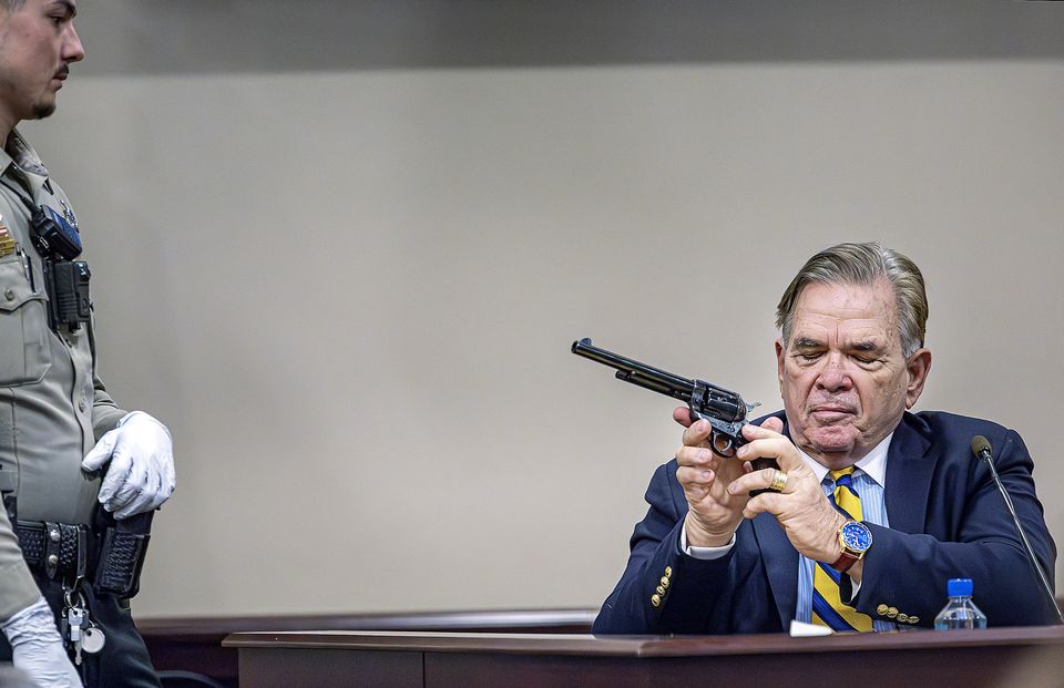 Santa Fe County Deputy Levi Abeyta, left, watches as firearms expert for the defence Frank Koucky III demonstrates how to uncock a gun like the one used on the set of the movie Rust (Jim Weber/Santa Fe New Mexican via AP, Pool)