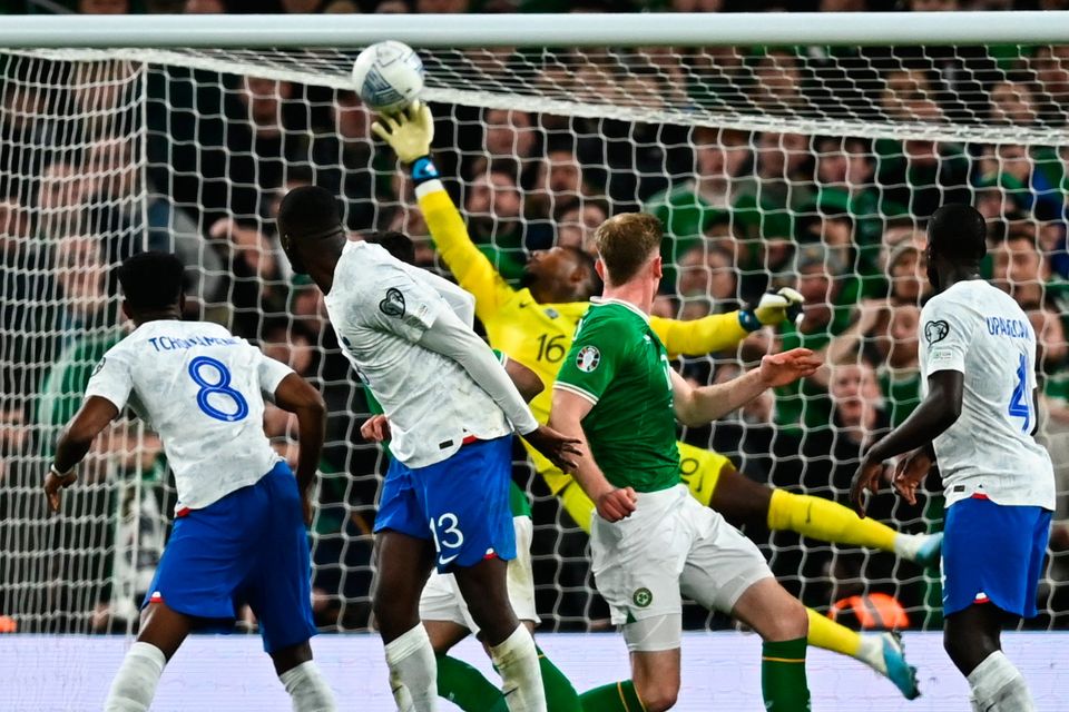 Nathan Collins sees his later header saved by France goalkeeper Mike Maignan. Photo by Eóin Noonan/Sportsfile