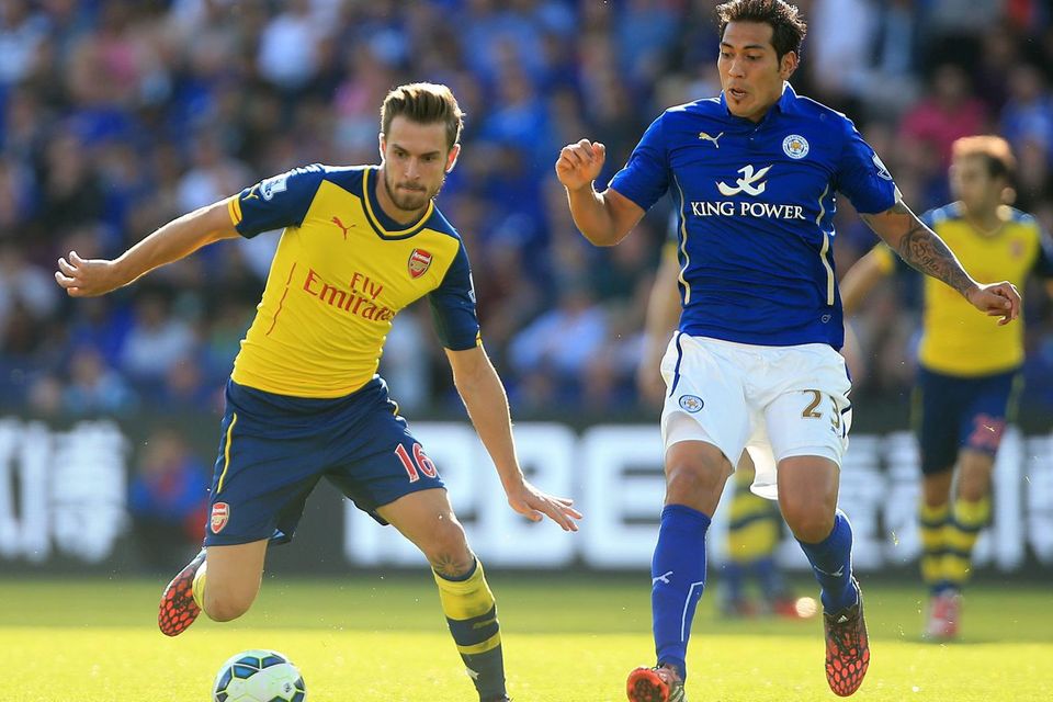 Leicester City's Leonardo Ulloa (right) and Arsenal's Aaron Ramsey (left) battle for the ball