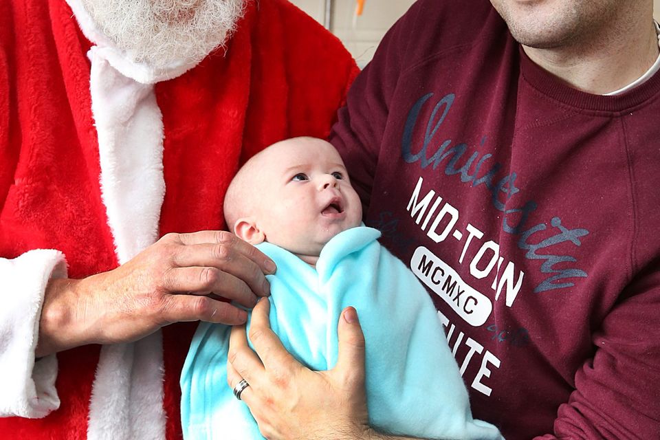 Santa delivers presents to seven-week-old Kai Kelly Knowles and dad James