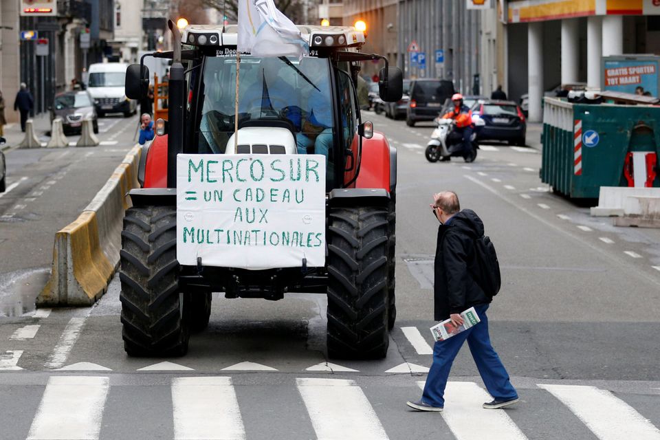 A sign reading "Mercosur = a gift to multinationals" is pictured on a tractor during a protest by Belgian farmers outside a meeting of European Union agriculture ministers in Brussels, Belgium on Monday. Photo: REUTERS/Francois Lenoir