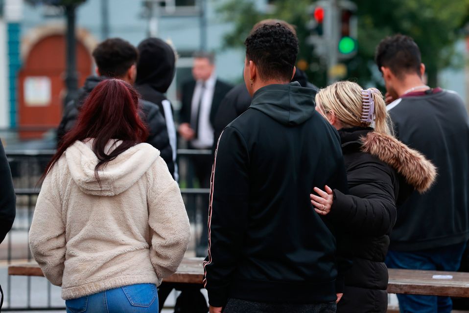Mourners outside the family home of Dlava Mohamed in Clones, Co. Monaghan. Photo: Liam McBurney/PA Wire