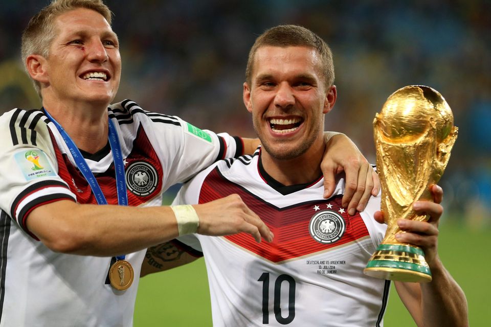 Germany's Bastian Schweinsteiger (left) and Lukas Podolski celebrate winning the World Cup
