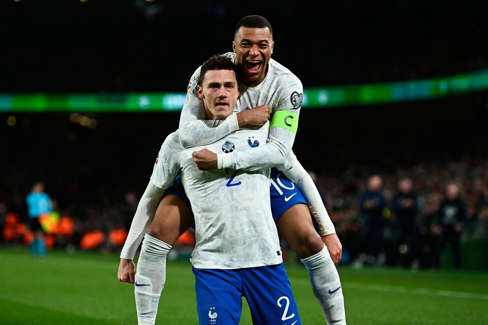 France's Benjamin Pavard, left, celebrates with team-mate Kylian Mbappé after opening the scoring against Ireland in their Euro 2024 qualifier at Aviva Stadium in Dublin. Photo by Eóin Noonan/Sportsfile