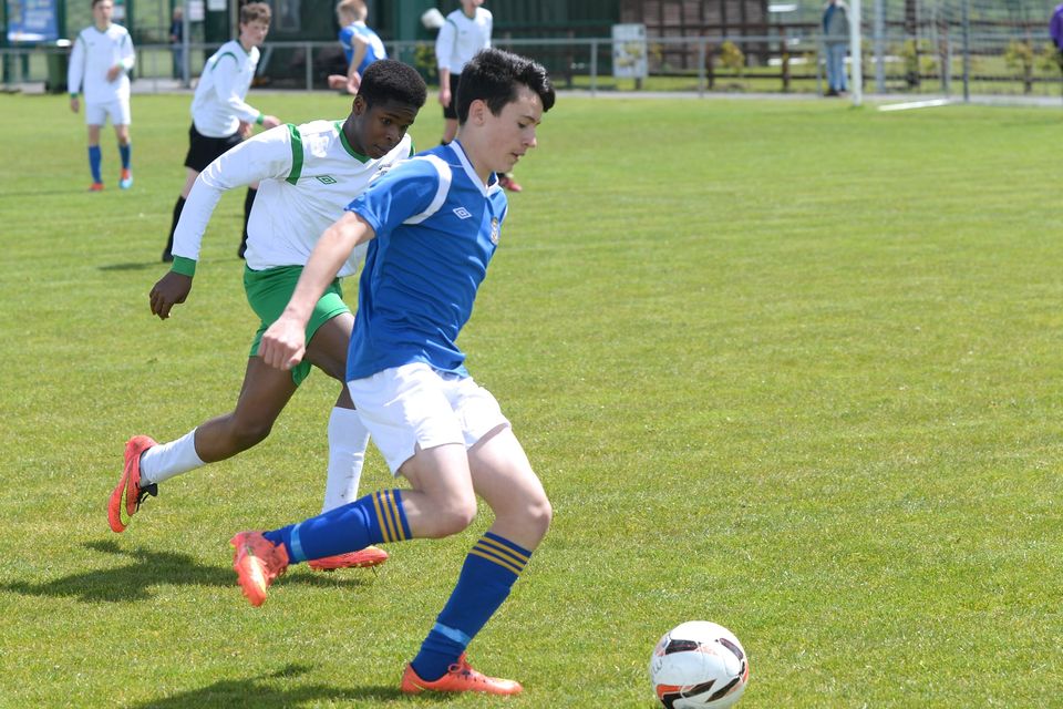 19/05/15. Miquel Barry under pressure from Tobe Ositelu during the Under 15s soccer final between Colaiste Phadraig CBS and Templeouge College at Peamount Utd.
Pic: Justin Farrelly.