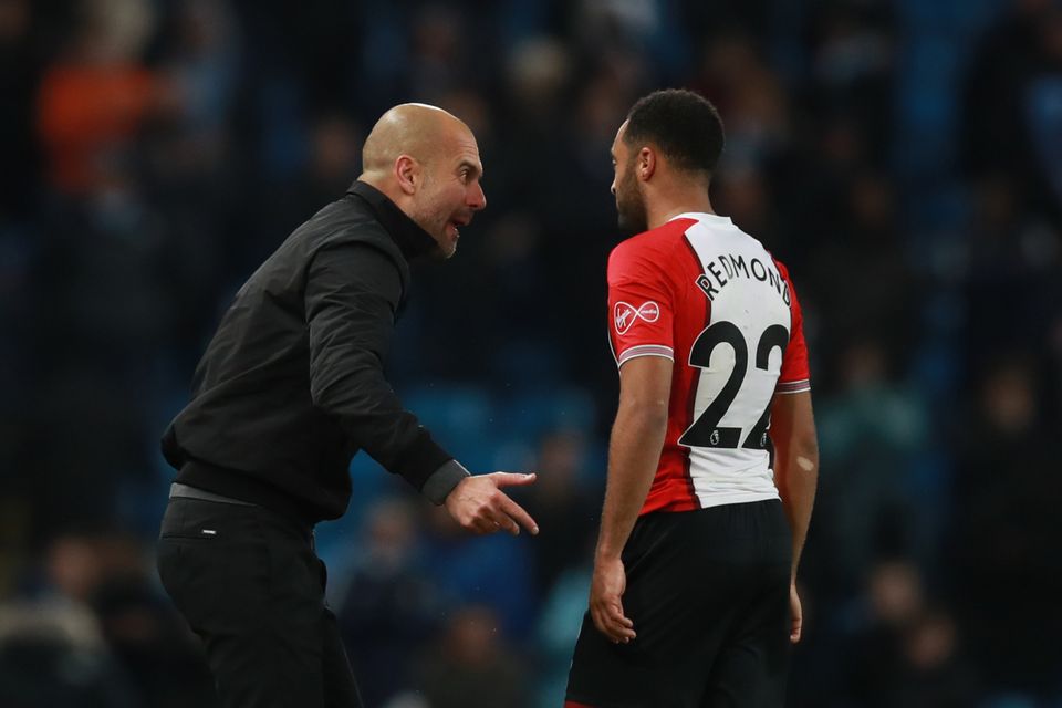 Pep Guardiola, left, had words with Nathan Redmond as the players leave the field