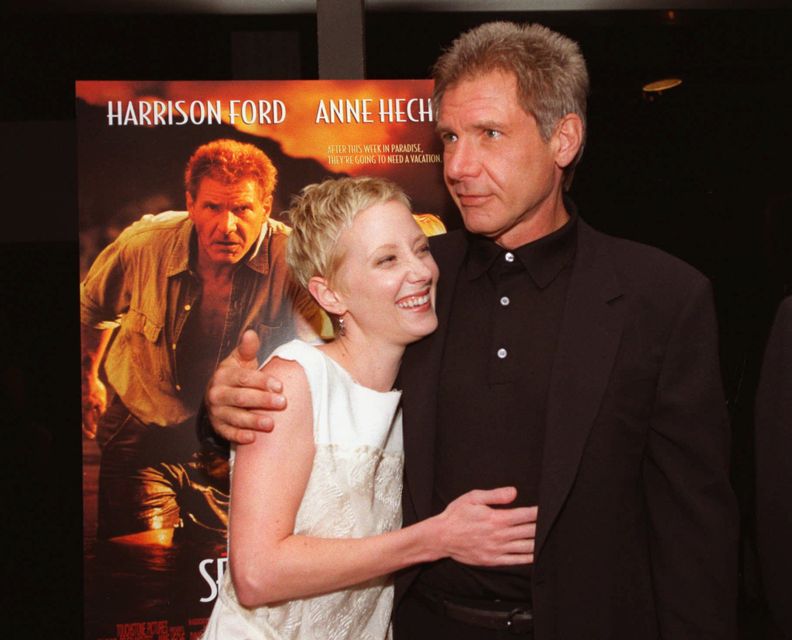 FILE - Anne Heche, left, and Harrison Ford embrace at the premiere of their film, "Six Days, Seven Nights" in the Westwood section of Los Angeles on June 8, 1998. Heche, who first came to prominence on the NBC soap opera â€œAnother Worldâ€ in the late 1980s before becoming one of the hottest stars in Hollywood in the late 1990s, died Sunday, Aug. 14, 2022, nine days after she was injured in a fiery car crash. She was 53. (AP Photo/Chris Pizzello, File)