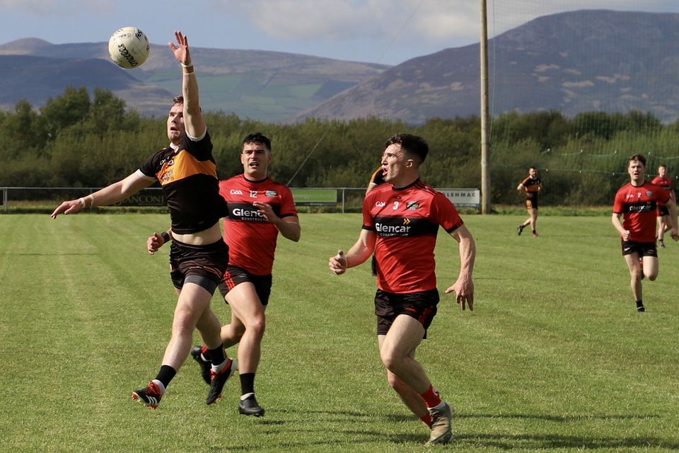 Austin Stacks' Greg Horan in action with Glenbeigh Glencar's duo of Caoilte Purcell and Tommy Quirke hot in pursuit in Saturday's game in Glenbeigh Photo by Michael G Kenny