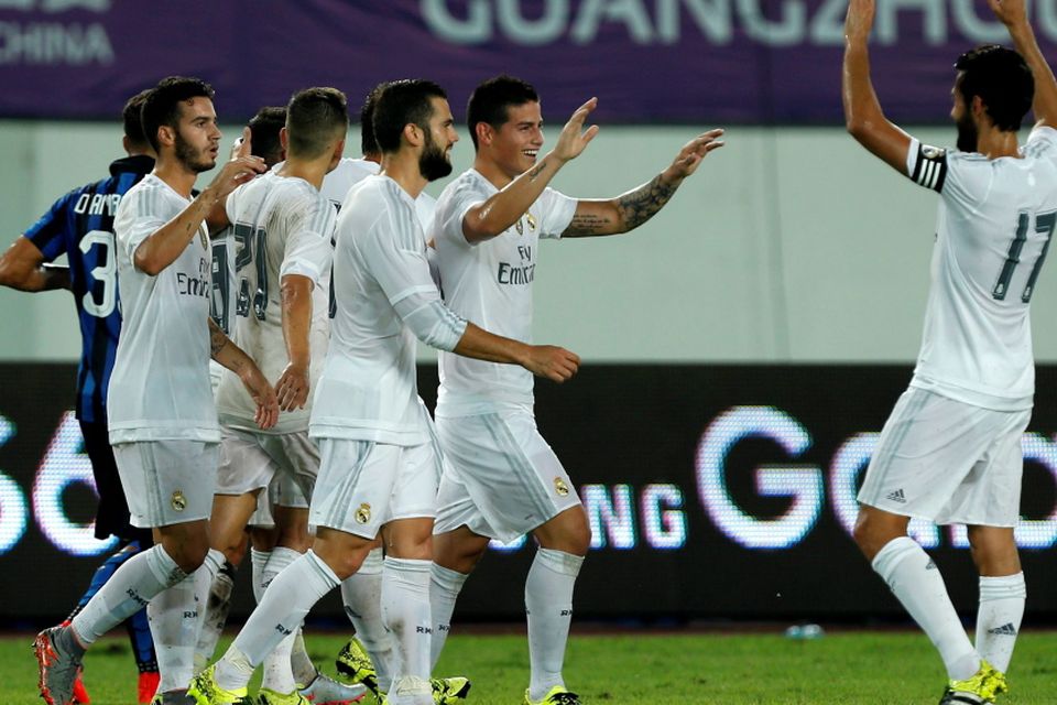 Real Madrid's James Rodriguez (2nd R)  celebrates his goal with team mates during their International Champions Cup against Inter Milan at Tianhe Stadium in the southern Chinese city of Guangzhou, China July 27, 2015. REUTERS/Tyrone Siu