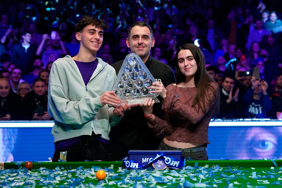 Ronnie O'Sullivan poses with the Paul Hunter trophy alongside his children Ronnie O'Sullivan Jr and Lily O'Sullivan after victory over Ali Carter in the MrQ Masters final at Alexandra Palace, London