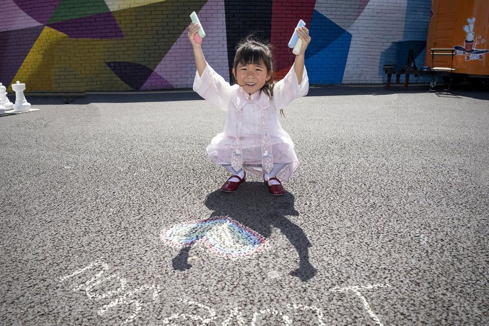 Aoife Kam creates some chalk art at ‘Summer at Honan’s Quay’ in Limerick city which was transformed into a recreational space by the river for people to enjoy. Photo: Don Moloney