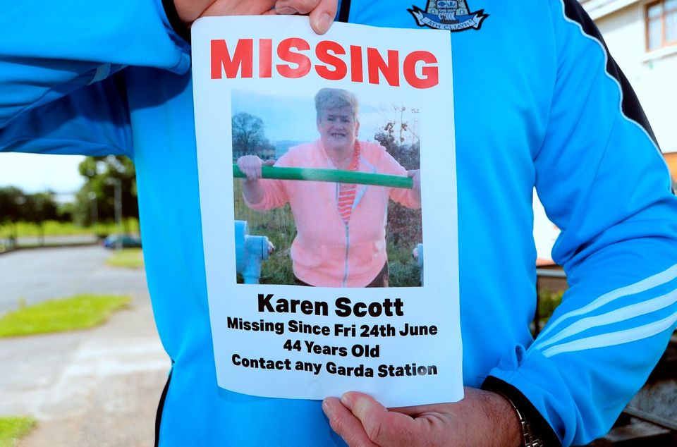 Next-door neighbour Robert Burke holds a Missing flyer for Karen Scott, missing since Friday 24th June.  Barnamore Grove, Finglas, Dublin. Picture: Caroline Quinn
