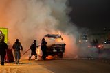 thumbnail: Egyptian firefighters extinguish fire from a vehicle outside a sports stadium in a Cairo's northeast district, on February 8, 2015 during clashes between supporters of Zamalek football club and security forces