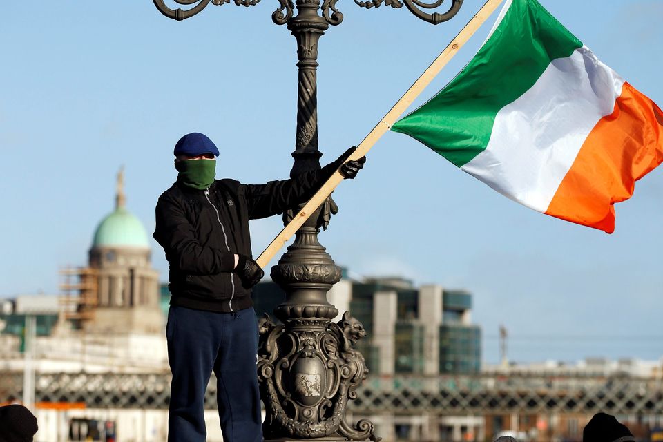 A man waves the national flag as water protesters march in Dublin. Photo: Reuters.