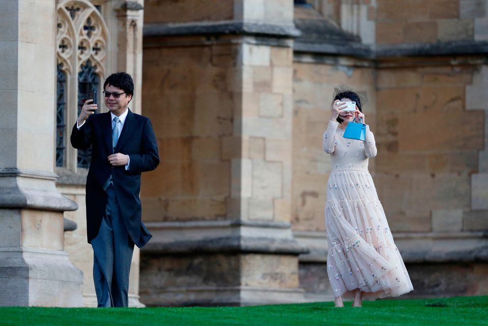 Guests take photographs as they arrive to attend the wedding of Britain's Princess Eugenie of York to Jack Brooksbank at St George's Chapel, Windsor Castle, in Windsor, on October 12, 2018. (Photo by Adrian DENNIS / POOL / AFP)ADRIAN DENNIS/AFP/Getty Images