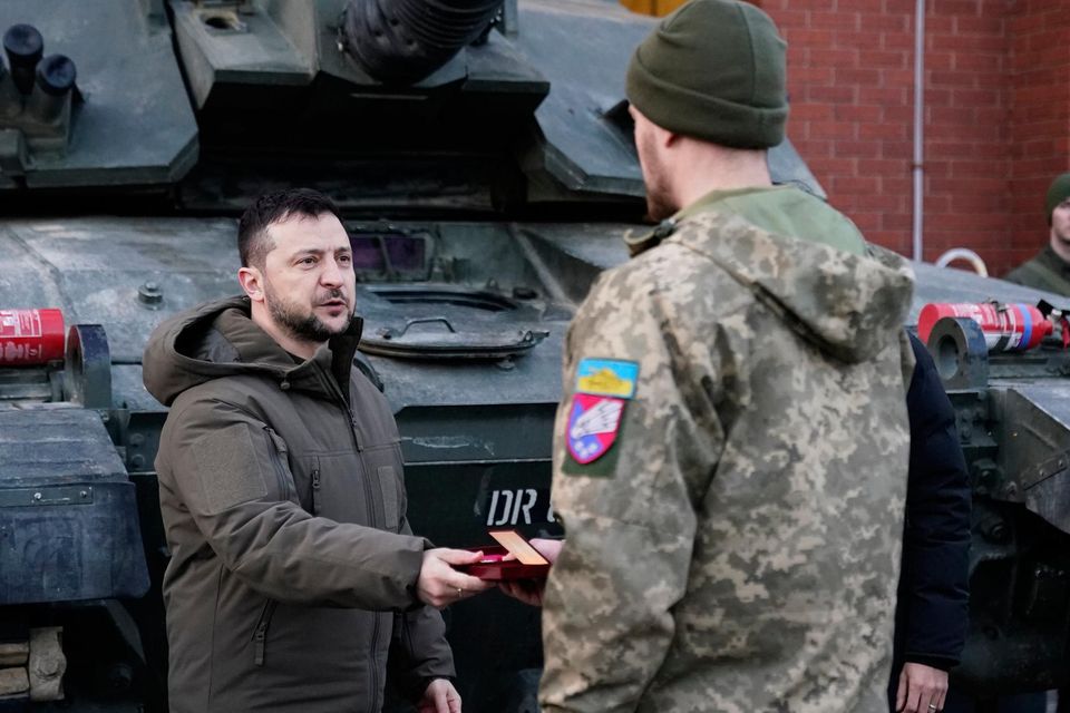 Ukrainian President Volodymyr Zelensky hands out medals to Ukrainian troops. Photo: Andrew Matthews/PA