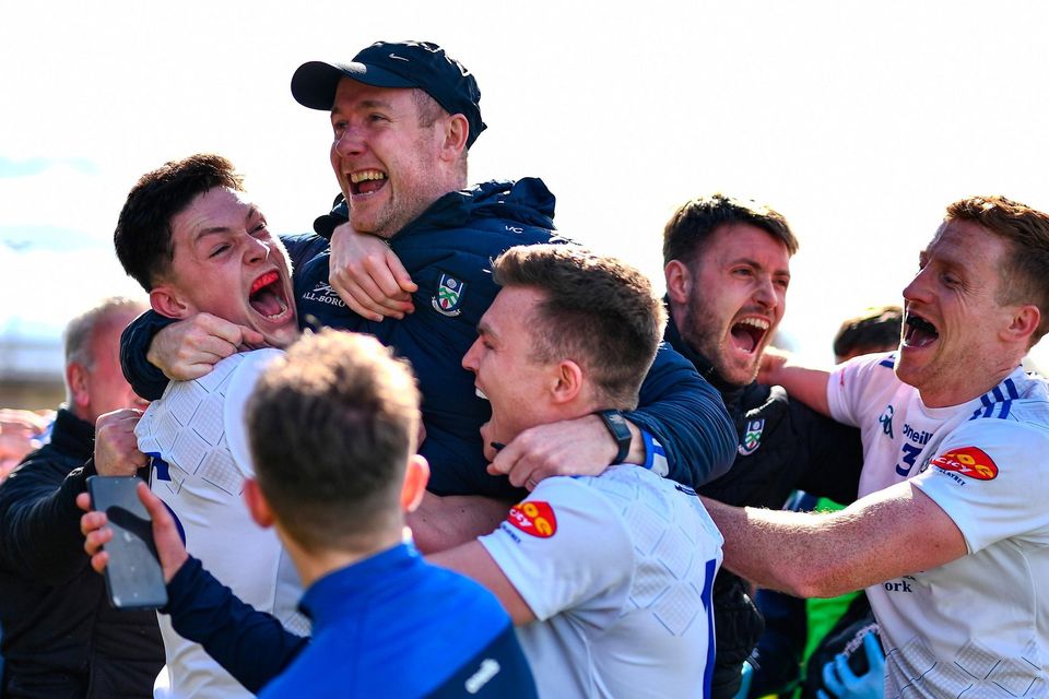 Monaghan players celebrate with their manager Vinny Corey after defeating Mayo in Division 1. Photo: Sportsfile