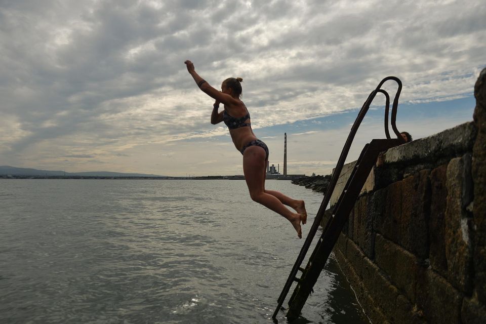 A swimmer takes a dip at the Great South Wall in Dublin Bay. Photo: Artur Widak/Getty