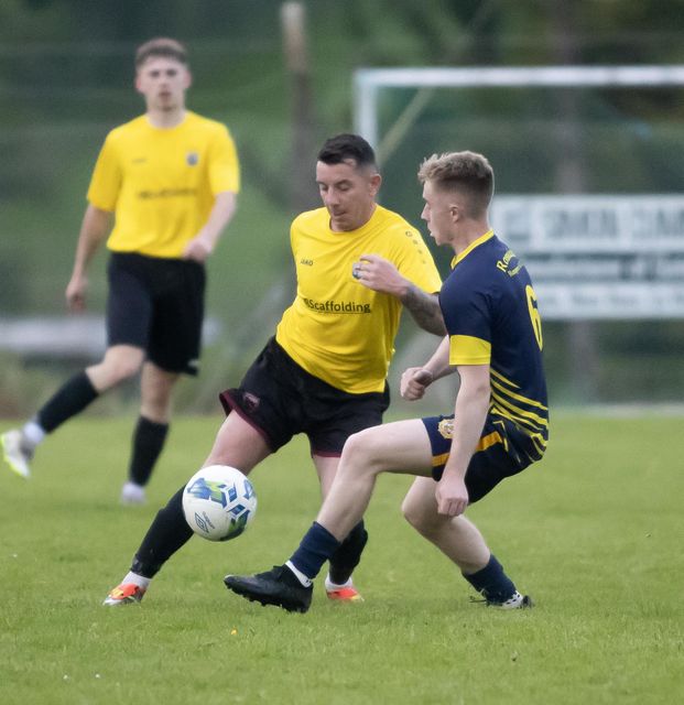 Ricky Rox of New Ross Celtic tries to go past Tadhg Brohan (Rosslare Rangers).