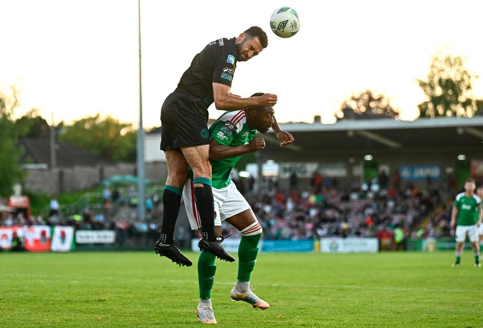 Tunde Owolabi of Cork City is tackled by Roberto Lopes of Shamrock Rovers during the game. Photo: Eóin Noonan/Sportsfile