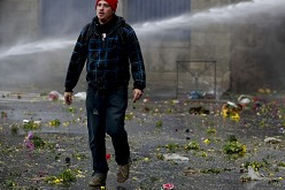 Riot police use water canons to disperse protesters during clashes in Quimper, France.