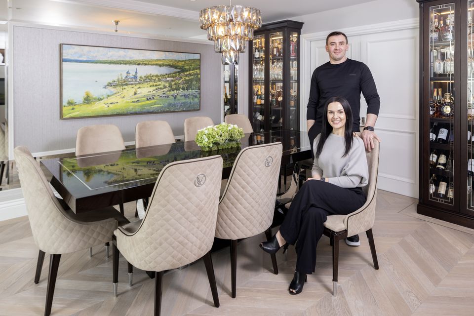 Ruslan and Antonia Sandulescu in the dining area. The sliding doors lead to the living room. They love to entertain  and the lacquered table which extends to seat ten is custom-made.  Photo: Tony Gavin