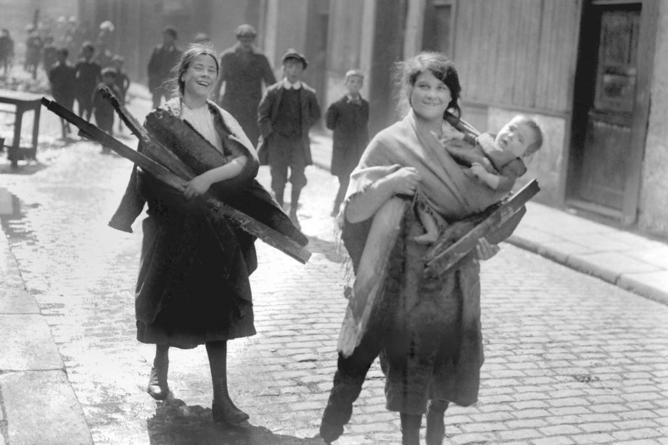 File photo dated 01/05/1916 of children carrying wood from Sackville Street, Dublin. Photo: PA/PA Wire
