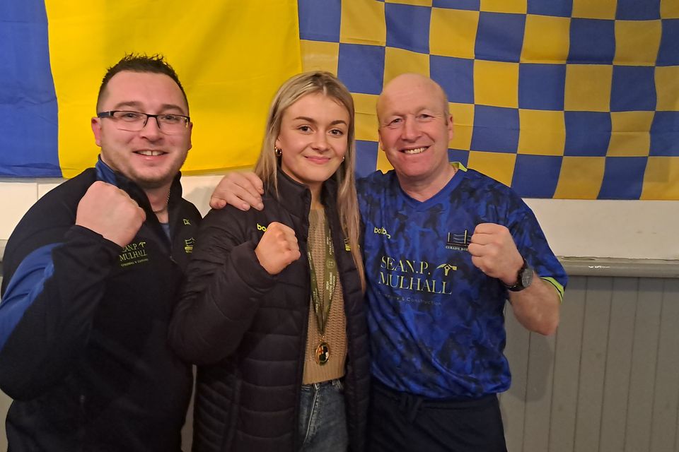 All-Ireland champion Ciofra Kenny with coaches James O'Brien and Darragh Kenny. 