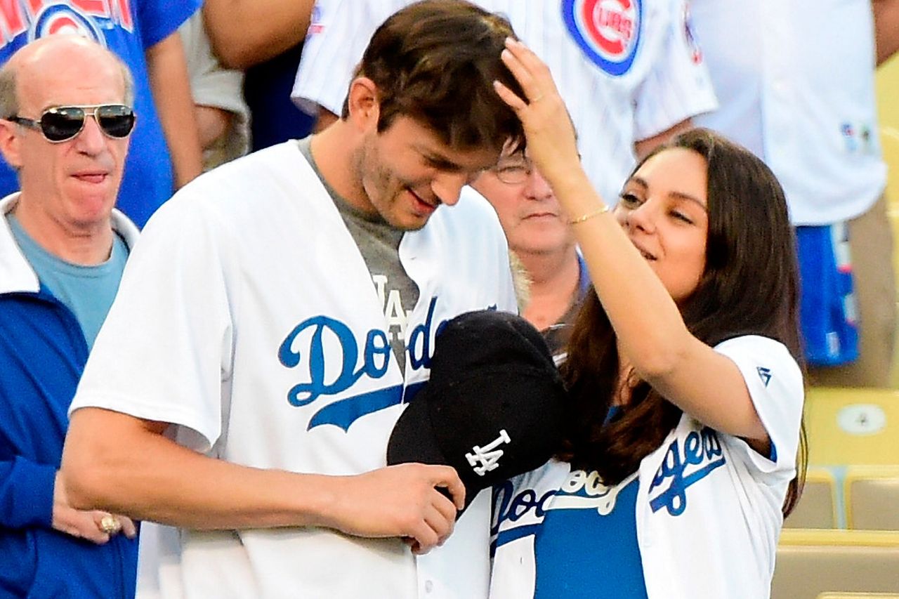 Pregnant Mila Kunis and hubby Ashton Kutcher put on PDA in matching outfits  at LA Dodgers crucial playoff game