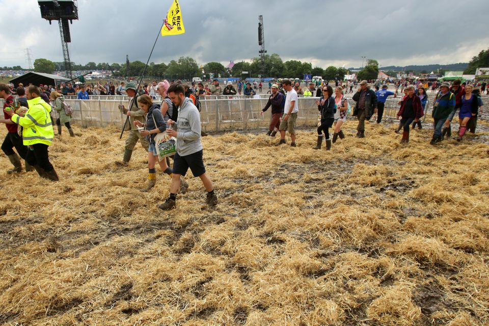 Hay is laid over the mud in front of the Pyramid Stage
