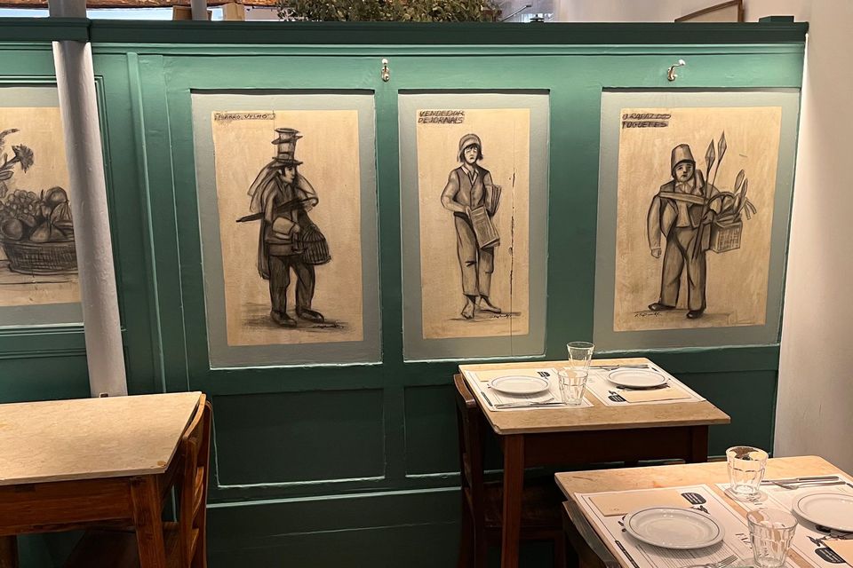 Images of traditional Portuguese laborers adorn the booths at Faz Frio. Bloomberg photo by Andrew Davis
