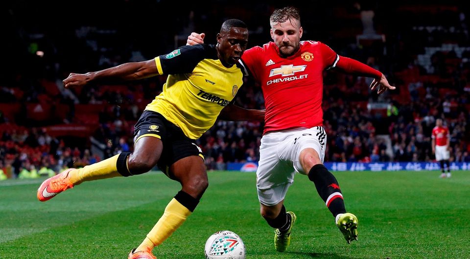 Burton Albion's Lucas Akins in action with Manchester United's Luke Shaw. Photo: Reuters