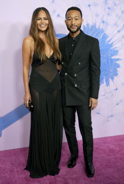 Chrissy Teigen, left, and John Legend arrive at the Green Carpet Fashion Awards (Jordan Strauss/Invision/AP)