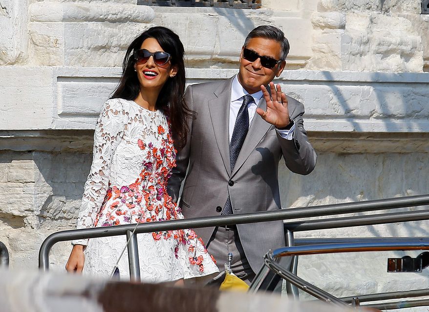 U.S. actor George Clooney and his wife Amal Alamuddin leave the seven-star hotel Aman Canal Grande Venice