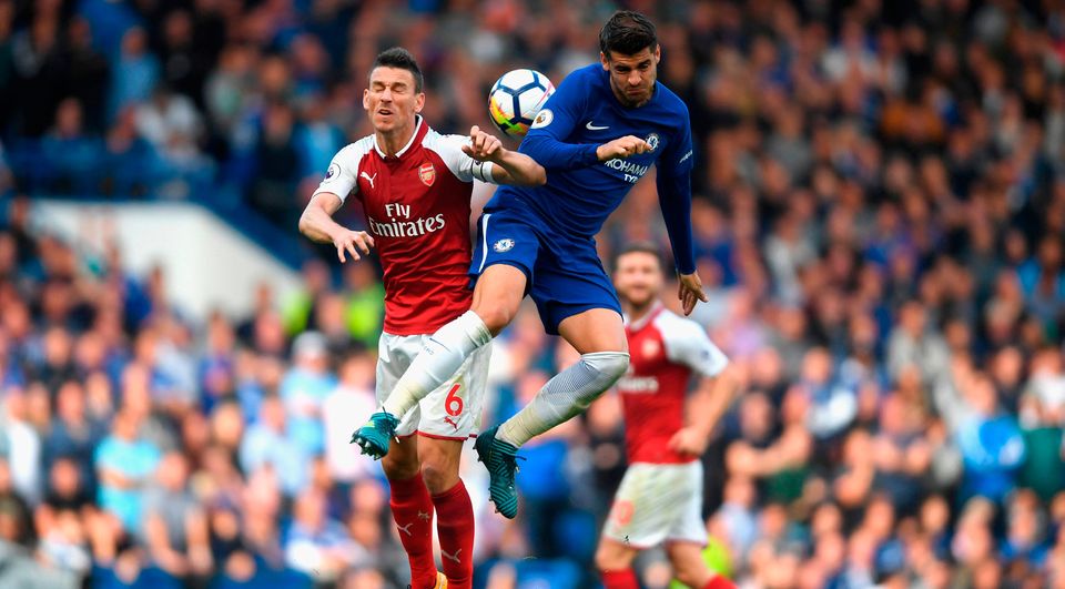 Laurent Koscielny of Arsenal and Alvaro Morata of Chelsea battle for possession in the air.  Photo by Mike Hewitt/Getty Images
